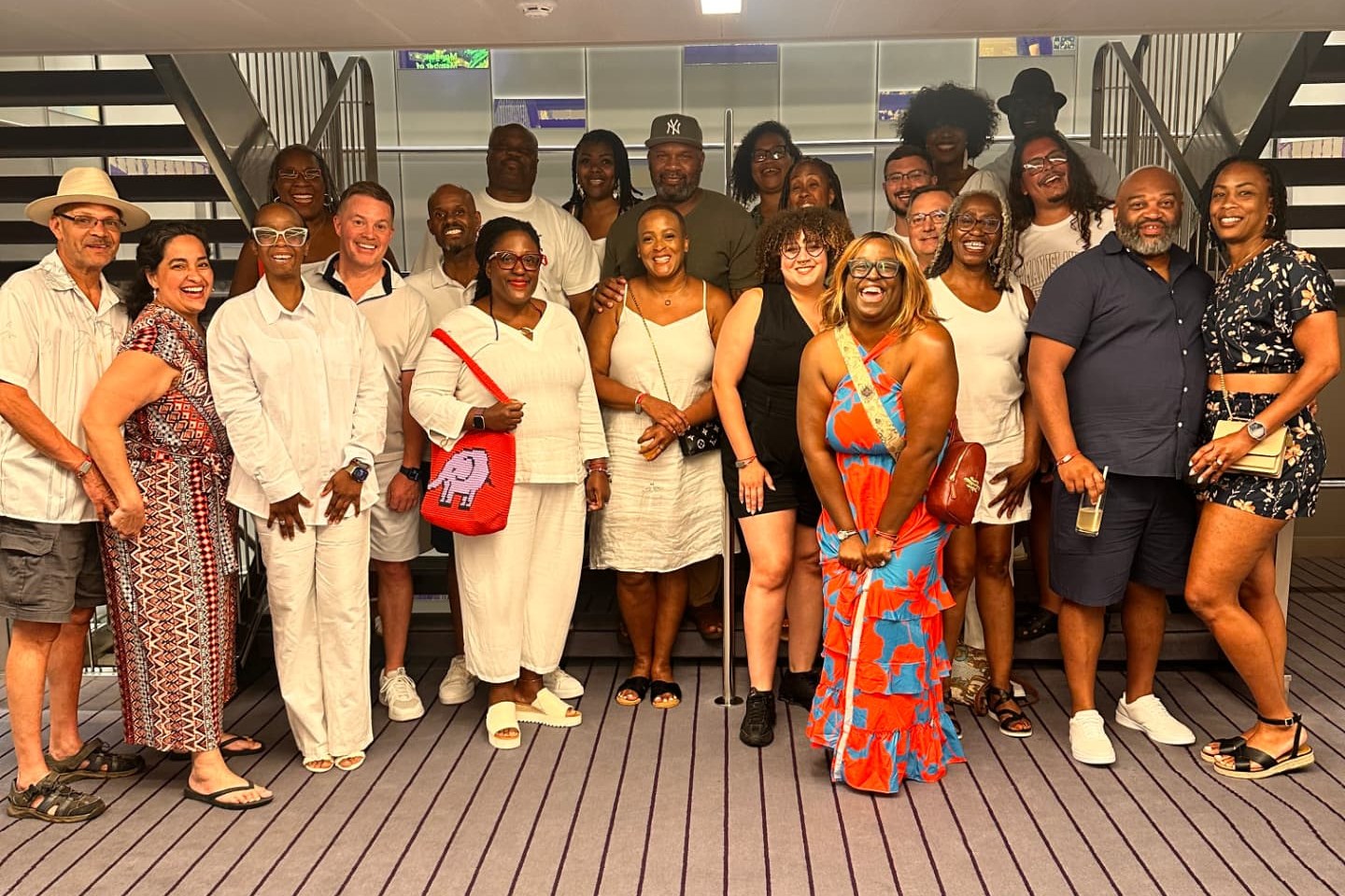 Hosted cruise group posing together aboard a ship